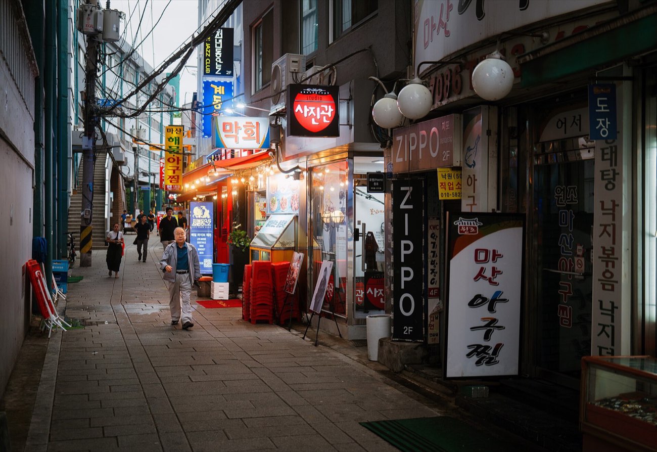 Bar signs lighting a narrow Seoul alley at night